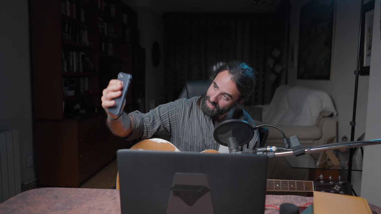 Man taking a selfie while recording music at home