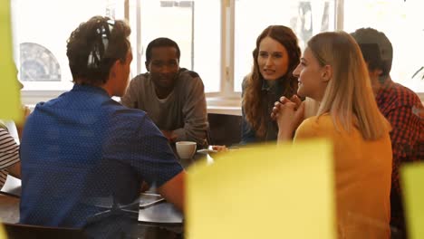 male and female business executives interacting with each other in a meeting