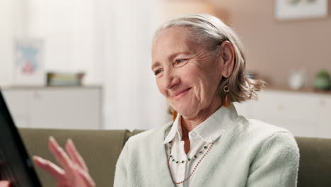 senior woman using tablet for video call