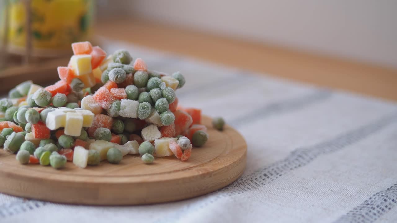 Frozen mixed vegetables on a wooden plate
