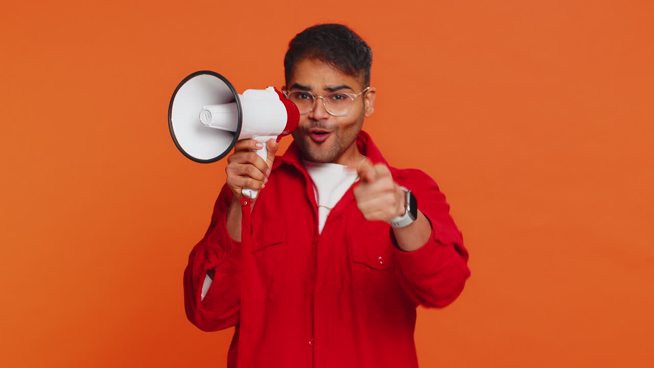 Indian man talking with megaphone proclaiming news loudly announcing advertisement discounts sale