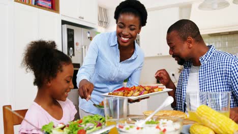 Family-having-meal-on-dinning-table-at-home