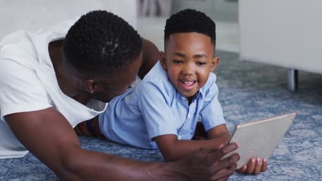 African-american-father-and-son-using-a-digital-tablet-together