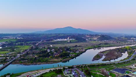 Aerial-dolly-in-of-Aconcagua-river-surrounded-by-vegetation-and-Mauco-Hill-in-background,-Valparaiso,-Chile