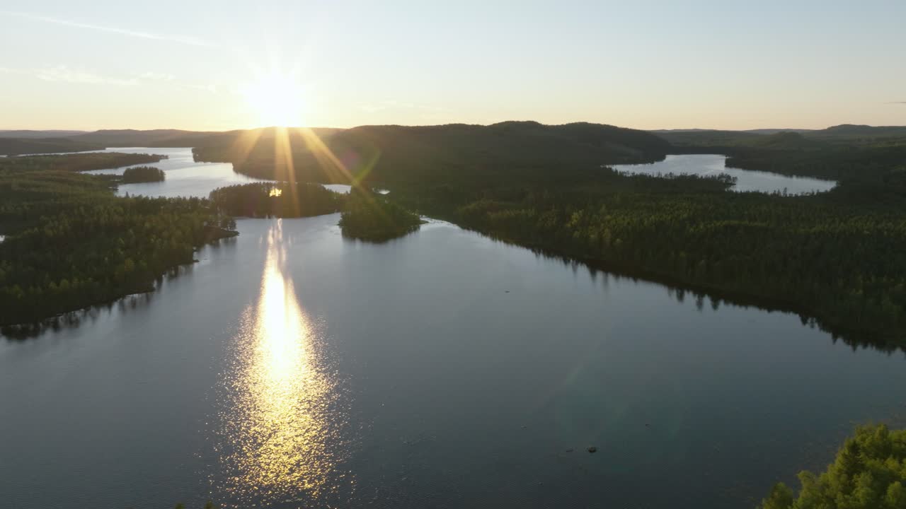 Drone pan left to right over sunset in Hälsingland woods Sweden