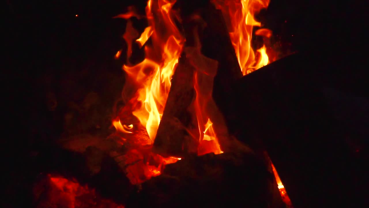 cámara lenta panorámica desde un fuego de campamento en una noche fría