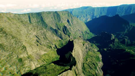 Gigantic-wide-angle-shot-of-drone-flying-into-the-huge-crater-of-cirque-du-Mafate-in-the-french-Island-of-La-Reunion