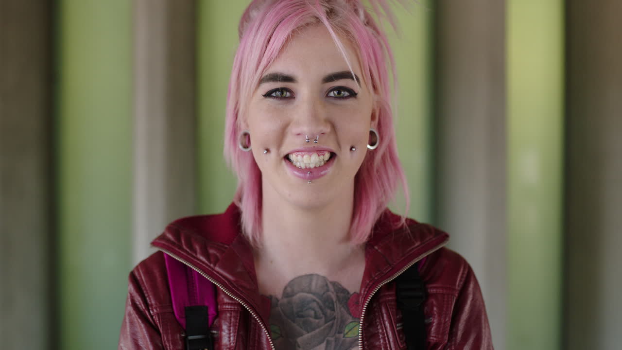 portrait of happy young woman tattoo body piercing looking happy student wearing red jacket