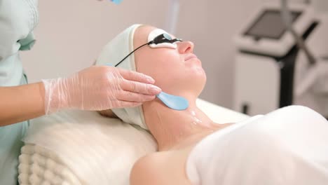 elos skin rejuvenation procedure. female with cooling gel and laser protection glasses in the modern cosmetology clinic. hardware cosmetology