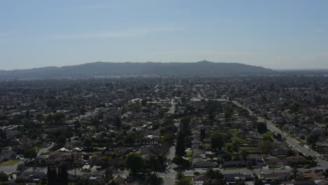 inland empire suburban sprawl houses with mountains in the distance aerial