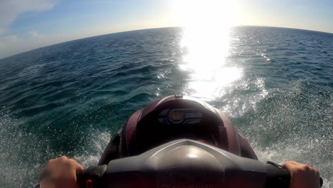 pov riding a jetski towards the ocean in the caribbean