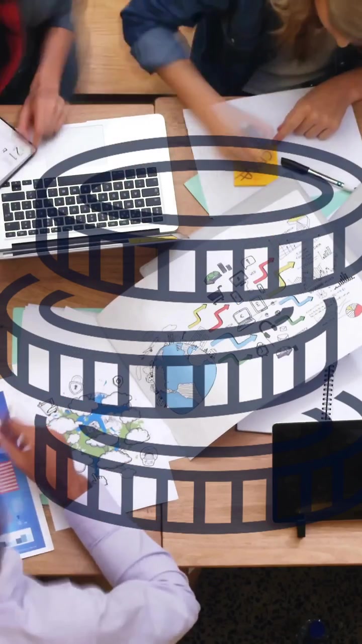 Film reel animation over group of people collaborating at desk with documents