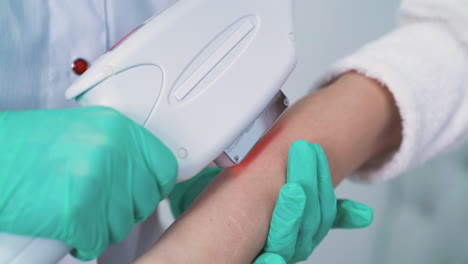 woman-in-gloves-does-laser-epilation-with-modern-equipment