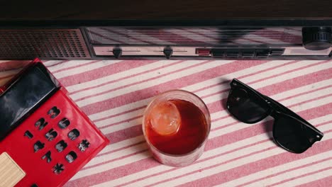 vintage style still life with retro phone, radio, and drink