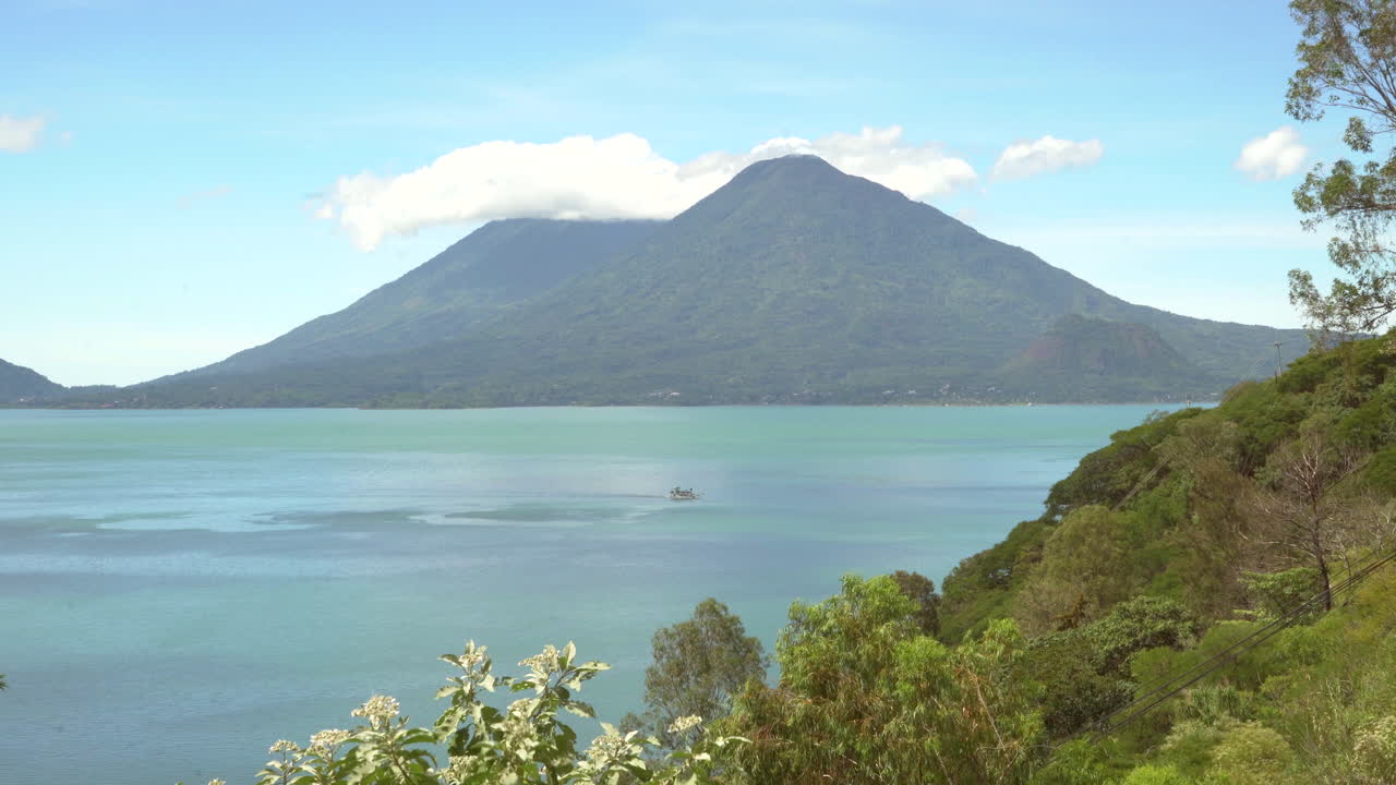 Lake Atitlán in Guatemala with an isolated boat on beautiful day