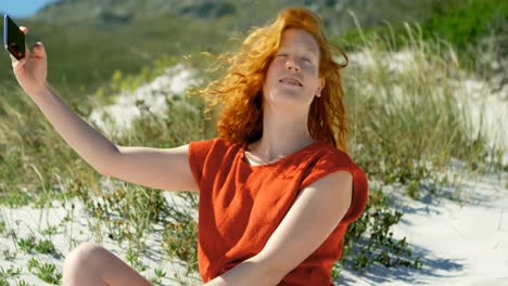 Woman-taking-selfie-with-mobile-phone-at-beach-4k