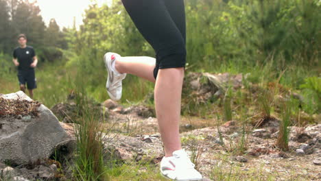 Couple-jogging-through-a-rocky-terrain