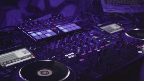 a backstage shot of the dj using his equipment in front of a crowd