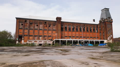 Old-abandoned-building,-low-angle-aerial-drone-view