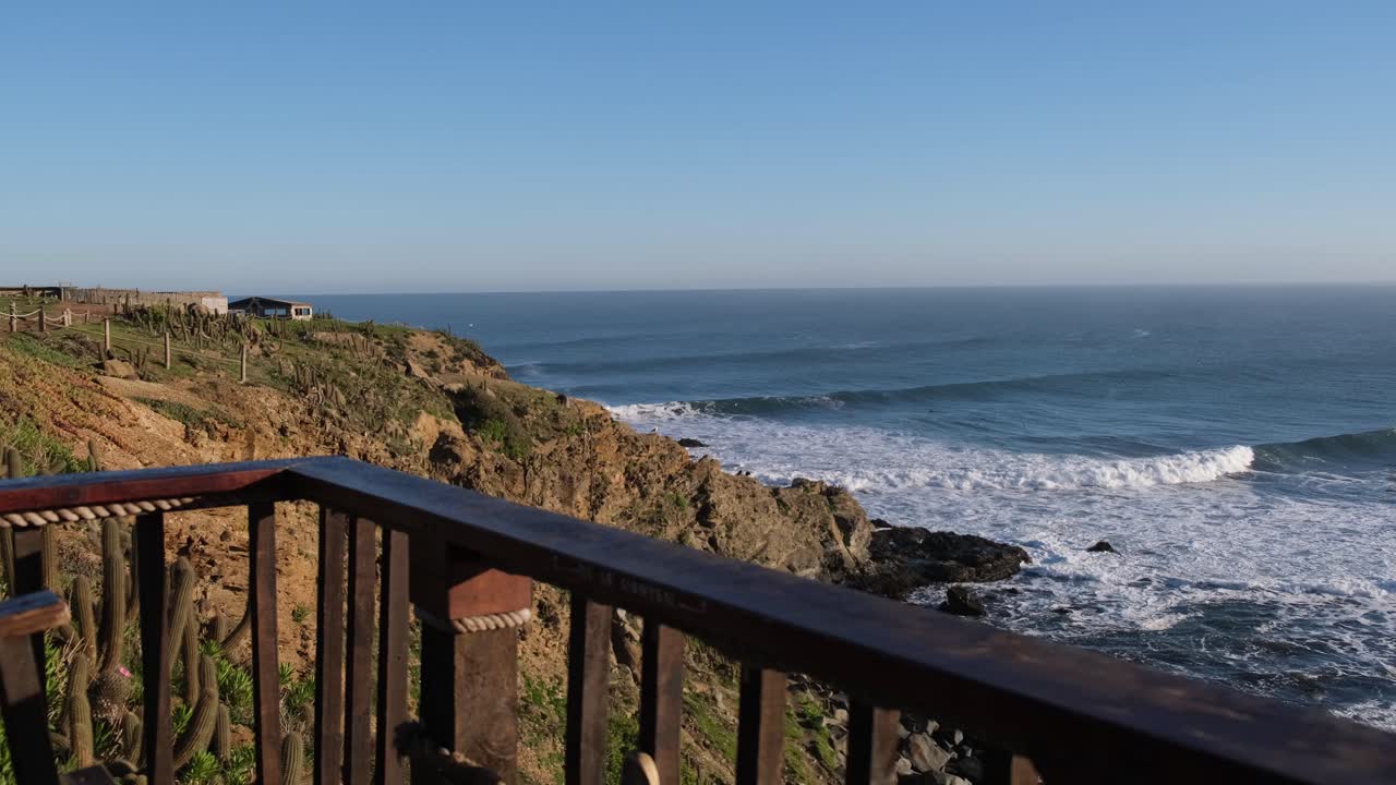 Man watching the ocean waves from a cliff