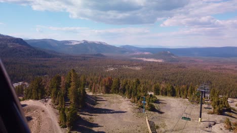 gimbal static shot from gondola passing over ski lifts on mammoth mountain in california during the summer