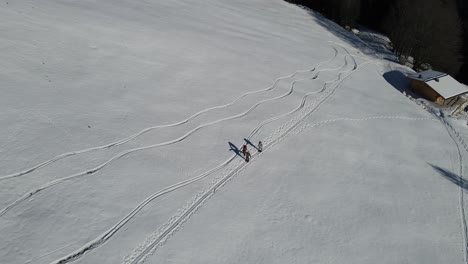 Aerial-shot-of-a-group-of-snow-shoe-hikers-in-the-mountains-of-austria