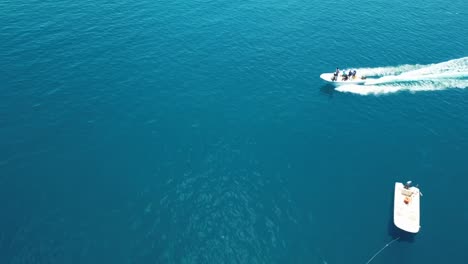 Drone-footage-of-a-Speed-boat-driving-by-on-turquoise-blue-sea-in-the-Indian-ocean-Maldives