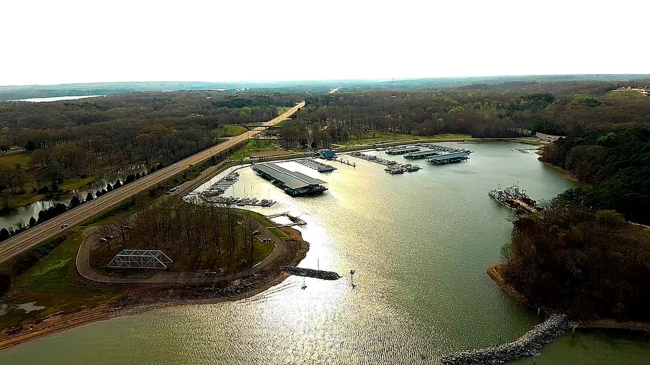 Aerial View of a Serene Marina and Lake Alongside a Highway