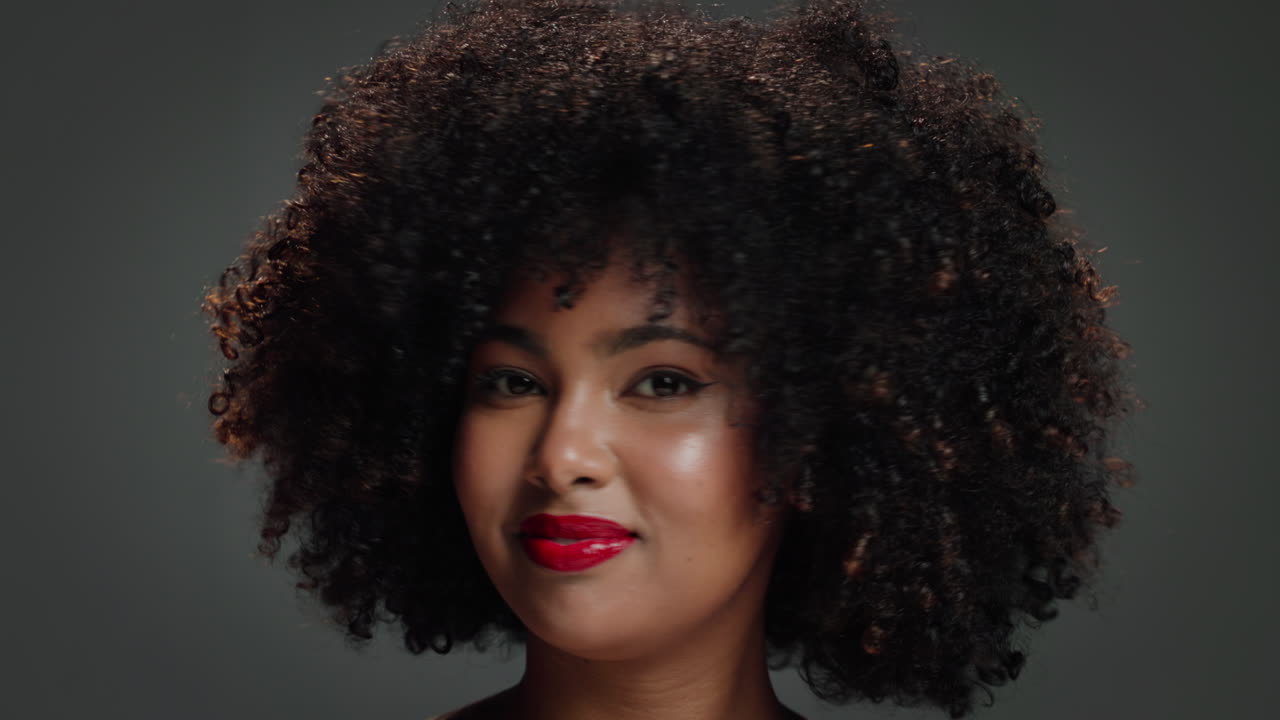 Portrait of a woman with afro hairstyle and red lipstick