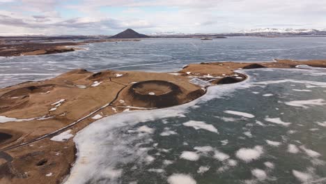 snow patched crater formations on frozen mývatn lake near skútustaðir in reykjahlíð region iceland