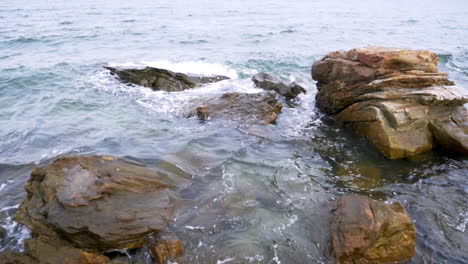 slow motion scenic landscape of nature sea wave coast to beach with stone and rock for summer vacation concept