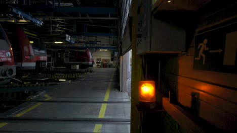 Dimly-lit-train-maintenance-facility-with-Deutsche-Bahn-trains-parked-during-twilight