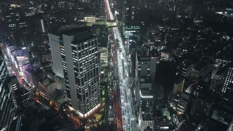 Traffic-At-Congested-Road-In-Shibuya-At-Night---Tokyo-Cityscape---high-angle,-wide-shot