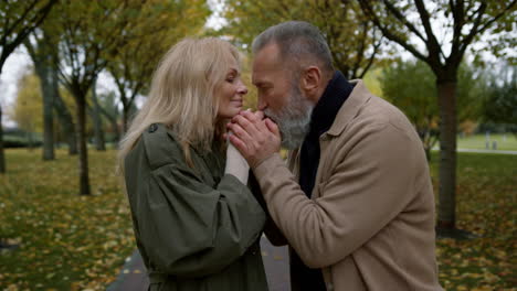 mature couple kissing hands of each other