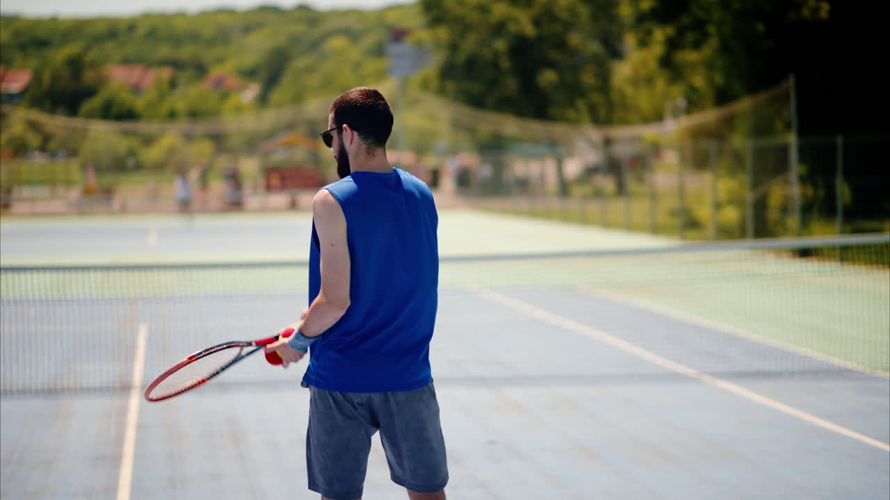 Two men playing tennis on a blue and green court on a sunny day