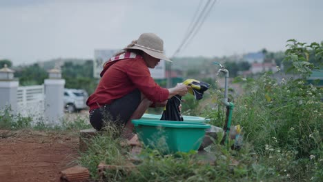 woman washing clothes outdoors