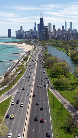 vertical drone shot of chicago usa cityscape skyline and traffic on lake shore drive