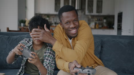 father and son enjoying video games at home