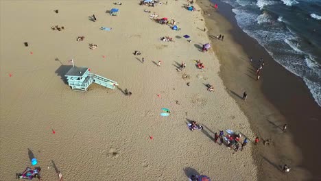 venice beach california drone shot panning left on beach front with sand and water