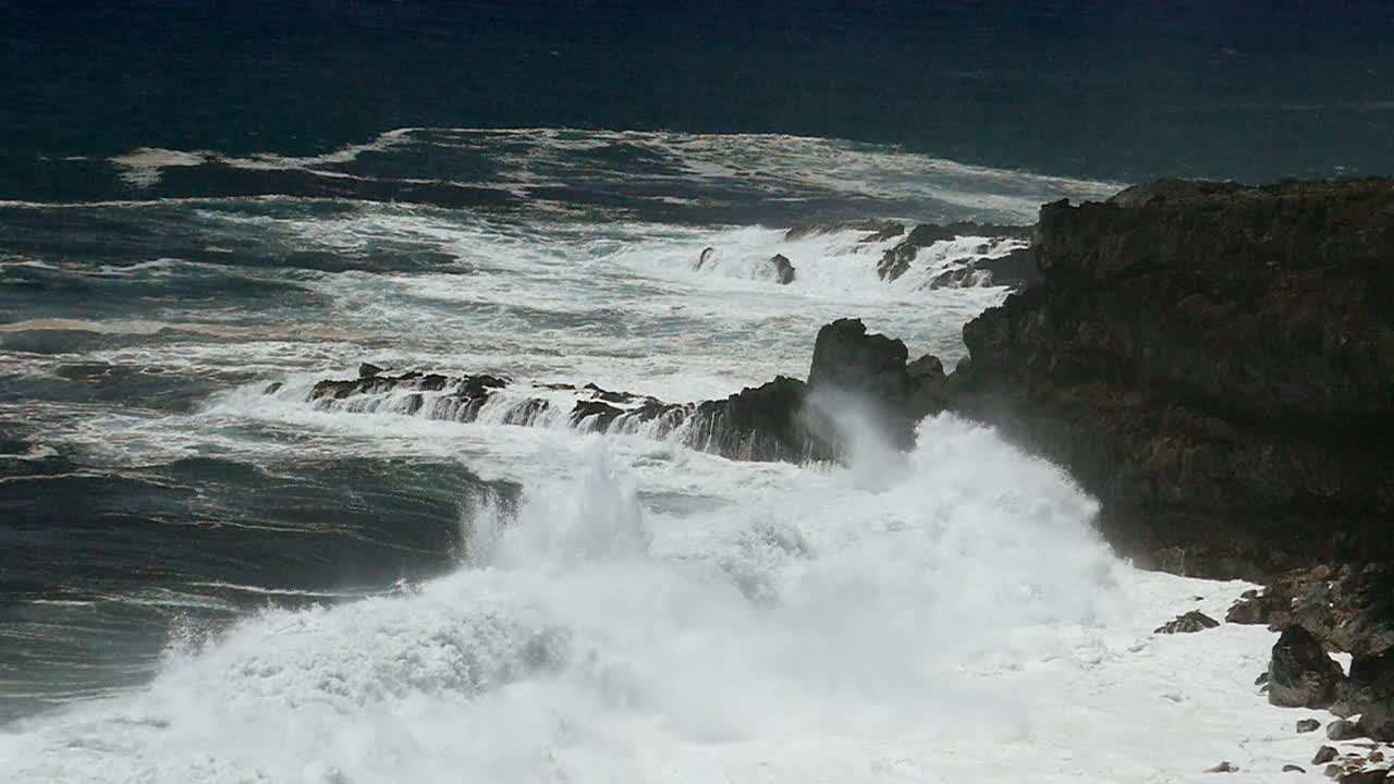 Powerful Waves Crashing on Rocky Coastline