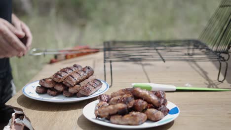 outdoor grilling of sausages and plating them