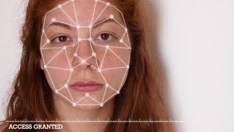 Close-up-of-a-young-woman-with-red-hair,-with-a-white-shirt-on-a-white-background,-with-facial-recognition-high-tech-animation-with-tracking-points-and-a-glow-effect-on-her-face,-with-"access-granted