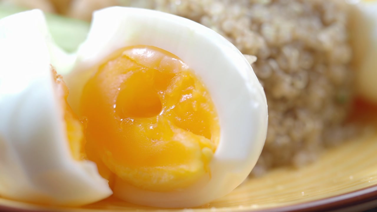 Close-up of a Soft-Boiled Egg with Runny Yolk and Quinoa