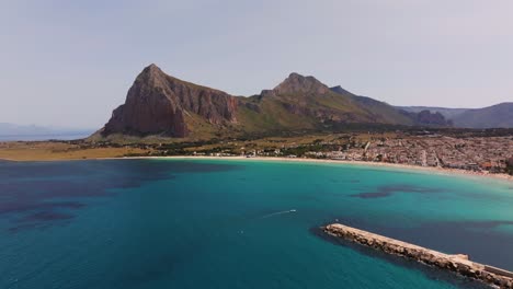 drone flies toward mount monaco above san vito lo capo beach town