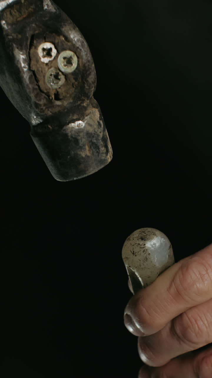 Close-up of a hammer and hands