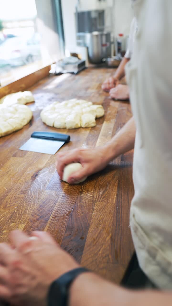 Bakery staff kneading dough