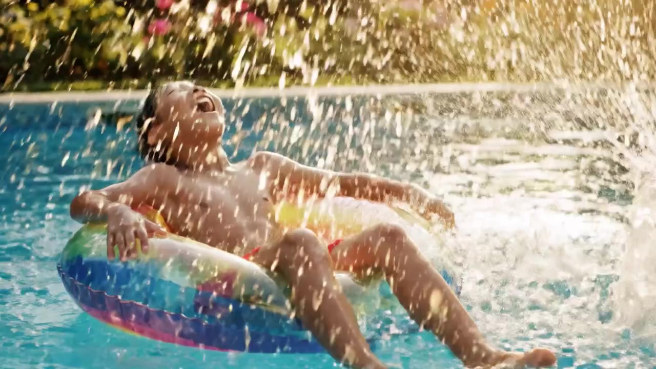 A Joyful Summer Afternoon: A Boy Relaxing on a Colorful Pool Float Surrounded by Vibrant Flowers and the Splendor of Nature