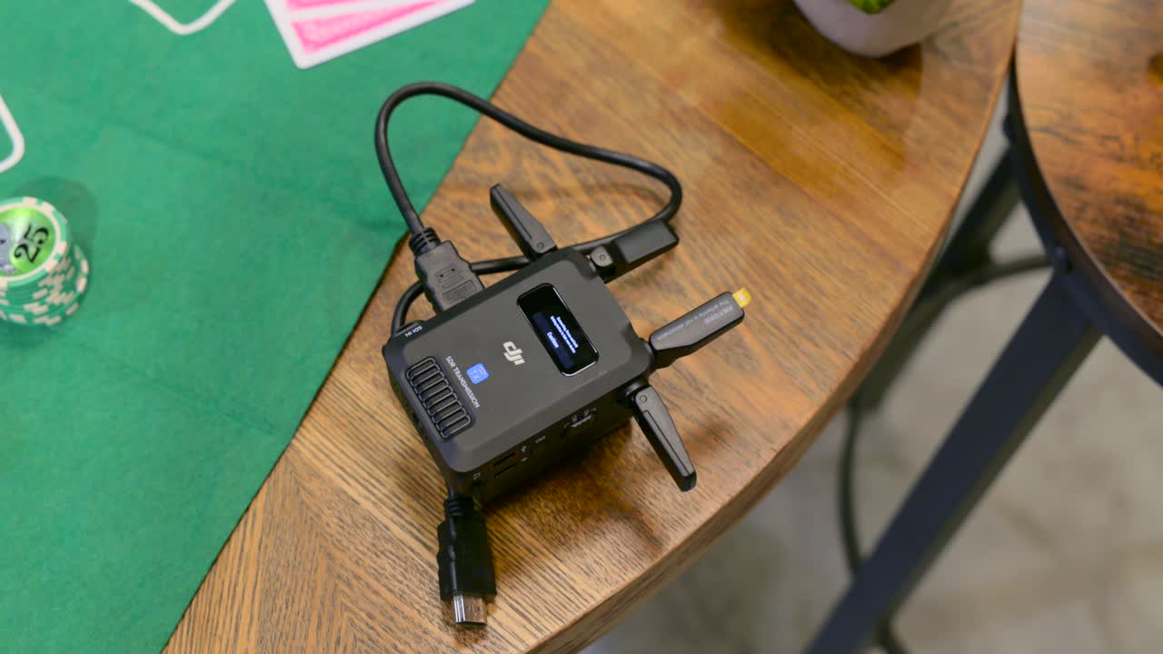 DJI SDR Transmission And Stack Of Poker Chips On Wooden Table. overhead, rotating shot