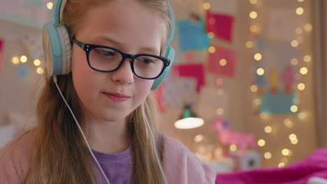 cute-little-girl-using-tablet-computer-listening-to-music-wearing-headphones-enjoying-online-entertainment-child-having-fun-with-portable-touchscreen-device-at-home