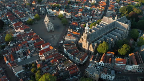 bird's eye view of saint-john church beside the market square in the cityscape of gouda, netherlands